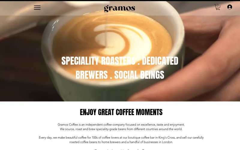 Screenshot of the Gramos Coffee homepage: a latte art photo with the words Speciality roasters, dedicated brewers, social beings.